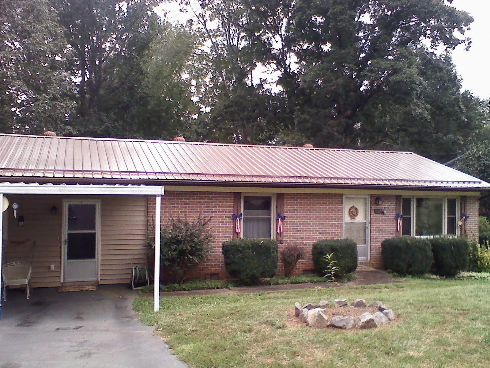 Bronze metal roof and carport on a brick ranch home — Roof Repair work by our crew in Dungannon