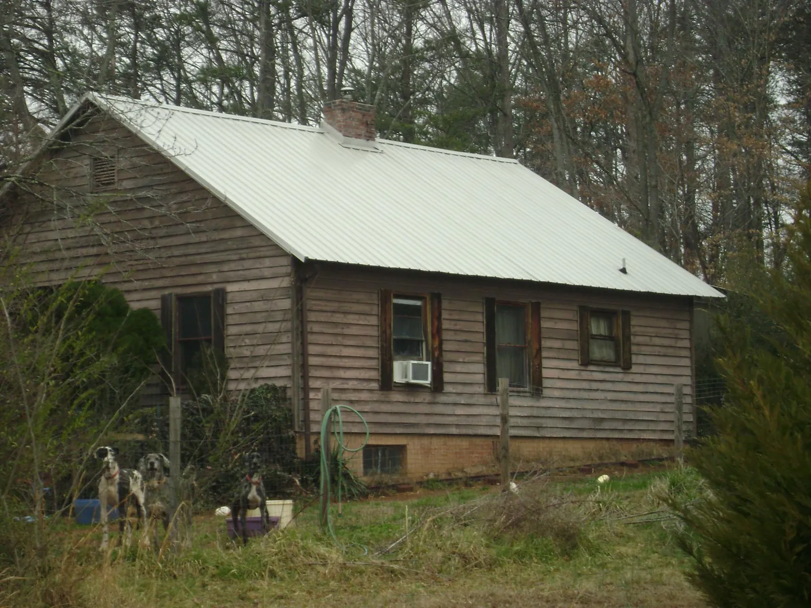 White metal roof on an old wood sided farmhouse, from a Metal Roof Installation job in Dungannon
